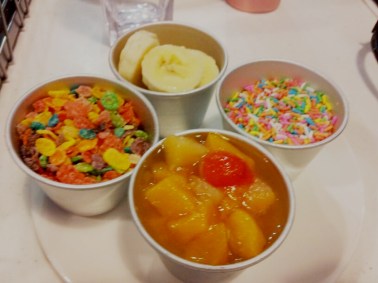 The toppings - rainbow sprinkles. banana slices, raisins and peach slices (which looked rotten so we didn't touch it at all)