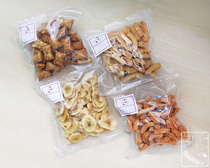 [100g packs] From bottom left, in anti-clockwise direction: Banana Chips, Chili and Lime Snippets, Honey Dijon Snippets, Peanut Butter Pretzels